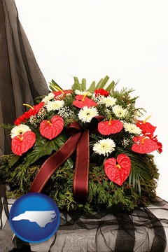 a funeral flower wreath - with North Carolina icon